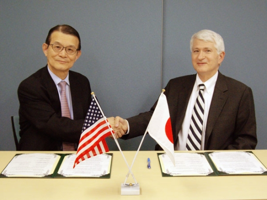 "Photo: Dr. Gene D. Block and Prof. Teruo Kishi shaking hands after the signing of the MOU." Image