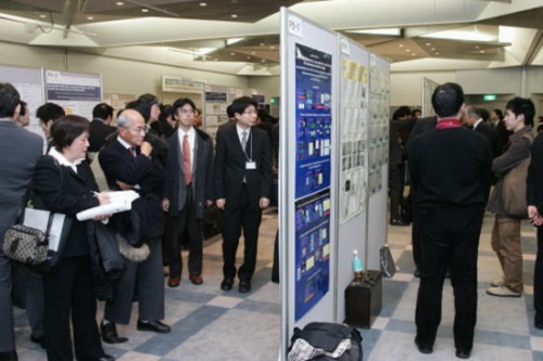 "The poster sessions by young researchers are held simultaneously with the mixer in the evening of the first day." Image