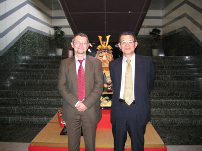 "Prof. Barsony poses with President Kishi in front of a samurai armor." Image