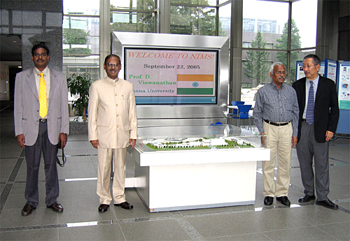 "Prof. Viswanathan, second left, poses in front of a welcome board with Prof. Murugesan, second right, Dr. Jayavel, far left, and Dr. Kitamura, far right." Image
