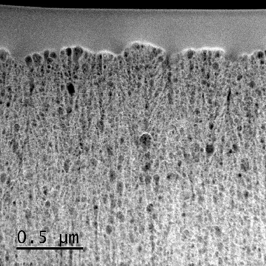"Figure. Transmission electron microscopy (TEM) image of the cross-section of a nanoporous, amorphous silicon film anode. The film anode was prepared using a sputtering deposition method using a reacting gas of helium." Image