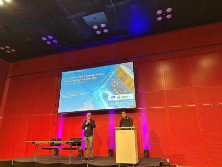 Mandai, team leader, delivering a keynote lecture on stage at the 76th ISE